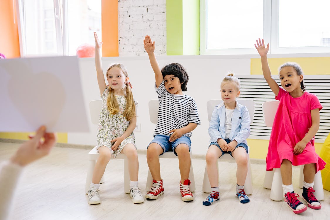 Image of children raising their hands